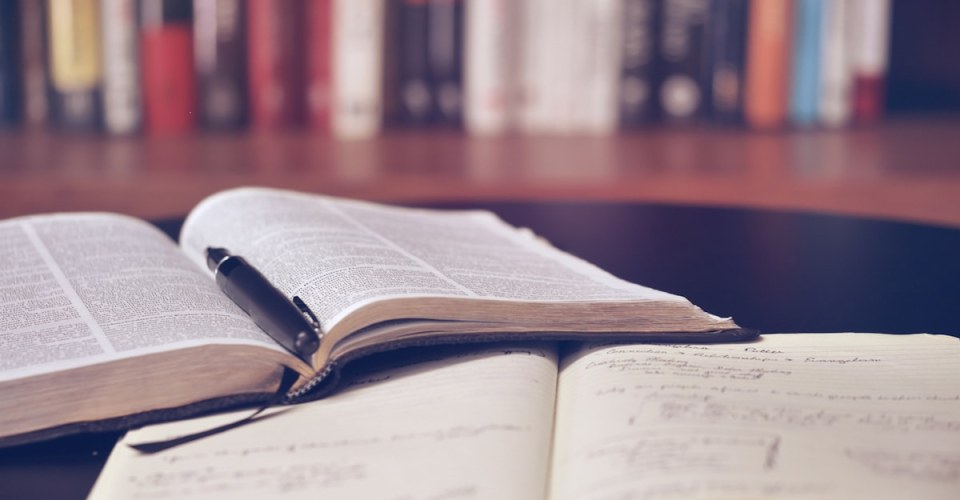 Researcher reviewing manuscripts for scholarly publication
